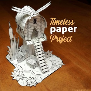 Könnte beinhalten: Ein schwarz-weißes Papierkunstwerk, das ein Baumhaus mit einer Libelle auf dem Dach darstellt. Die Szene umfasst eine Leiter, eine Bank und Papierpflanzen. Der Text "Timeless paper Project" ist oben rechts im Bild zu sehen.