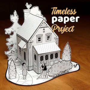 Puede incluir: Una casa de papel tridimensional con exterior blanco y detalles de líneas negras. La escena incluye a una persona sosteniendo a un bebé, una persona rastrillando, árboles y un pájaro. El texto Timeless paper Project está en la esquina.