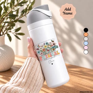 May include: A white stainless steel water bottle with a gray flip-top lid. The bottle features a colorful floral graphic, the text "NEVER FORGET THE DIFFERENCE THAT YOU MAKE", "PHYSICAL therapist", and the name "Olivia" with a small black heart.
