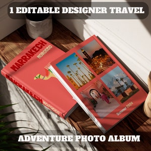 May include: Two red photo albums with white borders. The top album has the text "MARRAKECH MOROCCO" and a camel illustration. The bottom album has the text "Summer 2024" and photos of a city with palm trees and a street with an archway.
