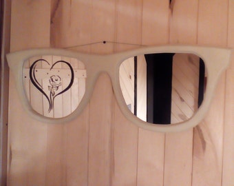 Sun glasses mirrors with an etched rose in a heart painted green that glows in the dark