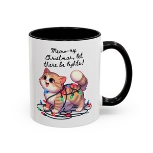 Meowry Christmas let there be lights Adorable Playful Kitty Tangled Christmas Lights Holiday Sips and Cheer Ceramic Coffee Mug Black Cat