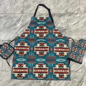 May include: A teal, red, white, and black patterned kitchen apron with matching oven mitts. The apron has a large pocket in the front and adjustable straps.