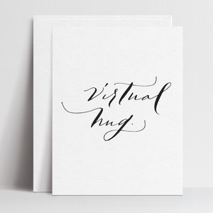 May include: A white card with black calligraphy that reads "virtual hug."
