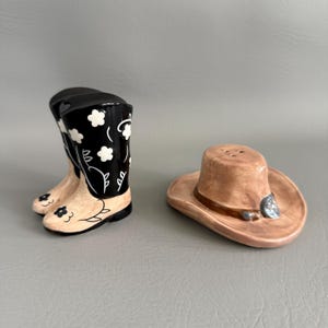 May include: A set of three ceramic mugs with a speckled, matte finish. The mugs are in shades of cream, light gray, and dark gray. Each mug has a simple, minimalist design, perfect for coffee or tea.