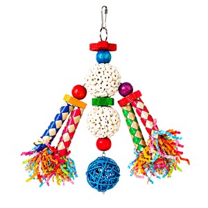 May include: A hanging bird toy featuring a central column of two white porous spheres, red and green wooden spacers, and a blue wicker ball at the base. Four braided straw limbs extend outward, accented with colorful paper streamers and beads.
