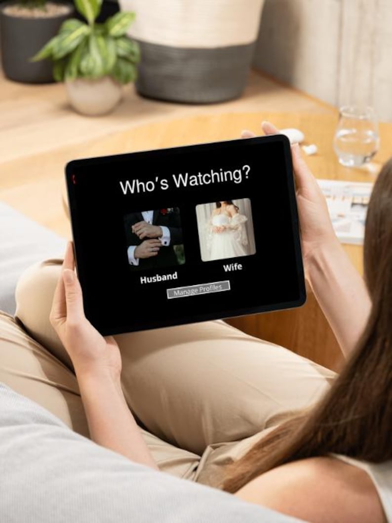 May include: A tablet screen displaying a Who's Watching interface with two profile icons. The left icon shows a person in a dark suit labelled Husband, and the right icon shows a person in a white dress labelled Wife. A Manage Profiles button is below.