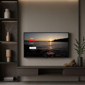 May include: A wall-mounted television displaying a sunset over water with the text Guess the Movie, Question, and Answer. The screen is centred on a vertical-slatted beige wall above a dark wood media console with open shelving and decor.