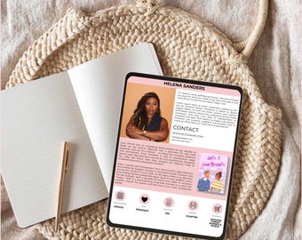 May include: A pink and white digital tablet displaying a book cover with the title "inks & heartbreaks". The book cover features a couple with a pink and blue background. The tablet also displays the author's name, Helena Sanders, and a description of the book. The tablet is on a woven straw bag.