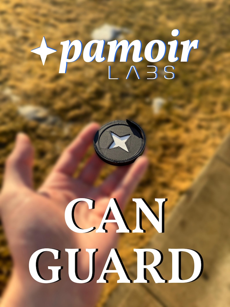 May include: A black camera lens cap with a white star in the center. The text "pamoir LABS" and "CAN GUARD" are visible in the image.