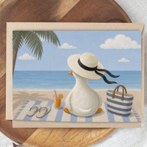 May include: Greeting card featuring a whimsical illustration of a white duck wearing a sun hat, relaxing on a beach towel. The scene includes a beach bag, flip-flops, and a refreshing drink, with a palm tree and ocean in the background.