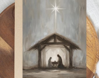 May include: A Christmas card featuring an artistic depiction of the Nativity scene. The image shows a wooden stable with the silhouettes of Mary, Joseph, and baby Jesus. A bright star shines above the stable, set against a muted, neutral background.