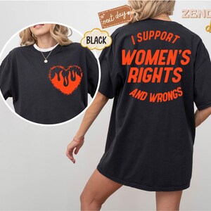 May include: Black t-shirt with a flaming heart on the front and the text "I support women's rights and wrongs" on the back.