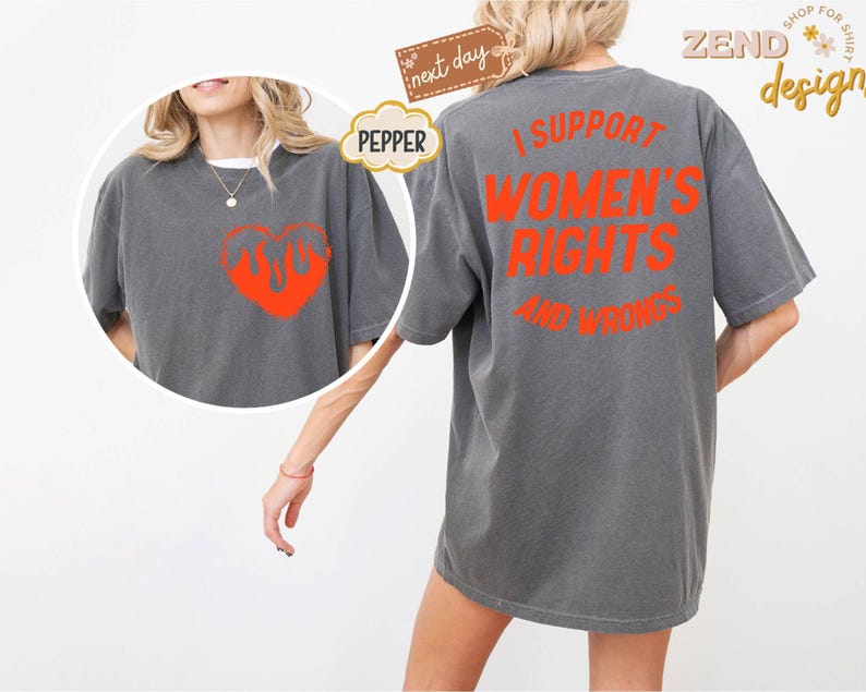May include: A gray t-shirt with the text "I support women's rights and wrongs" printed in orange on the back. The front of the shirt features a red heart with flames.