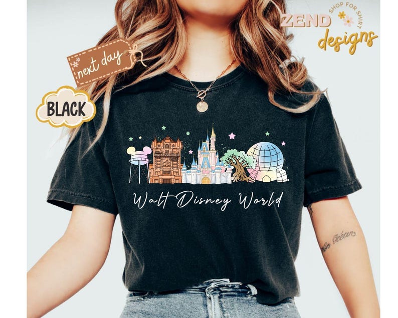 May include: Black t-shirt featuring a colorful illustration of Walt Disney World landmarks, including Cinderella Castle and Spaceship Earth. The words "Walt Disney World" are written below the graphic. A tag reads "next day".