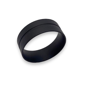 May include: A black rubber ring with a raised seam. The ring is about 1 inch wide and 2 inches in diameter.