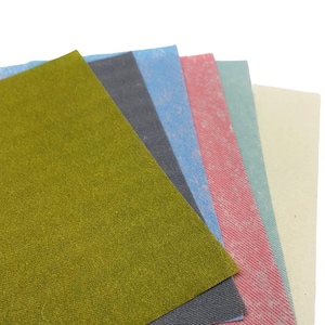 May include: A set of six different colored felt sheets. The sheets are arranged in a fan shape, with the green sheet on top. The other sheets are blue, light blue, pink, light green, and beige.