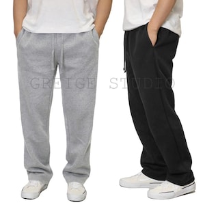 May include: Two pairs of sweatpants, one gray and one black, with a drawstring waist and side pockets. The sweatpants are shown on two different models.
