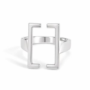 May include: A polished silver-tone ring featuring a prominent open rectangular design on the front. The band is smooth and solid, connecting to two vertical bars that face each other with small horizontal extensions at the top and bottom ends.