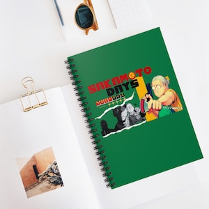 May include: A green spiral notebook with a torn paper design featuring the text "Sakamoto Days" in red and black. The text "サカモトデイズ" is also included in black. The notebook has a black and white illustration of a character holding a gun.