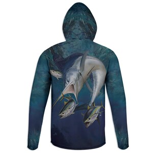 May include: A hooded long-sleeve shirt featuring a vibrant underwater scene. The design showcases a large marlin attacking several yellowfin tuna, set against a deep blue background. The hood and sleeves continue the aquatic theme.