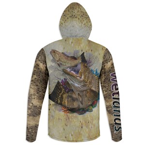 May include: A hooded long-sleeve shirt featuring a detailed illustration of two fish with open mouths, surrounded by coral and aquatic plants. The sleeves and hood have a speckled pattern. The word "Wetlands" is printed vertically on the right sleeve.