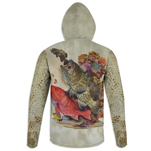 May include: A beige long-sleeve hoodie with a colorful fish and coral reef design on the back. The design features a large grouper fish with its mouth open, a red snapper fish, and a variety of coral.