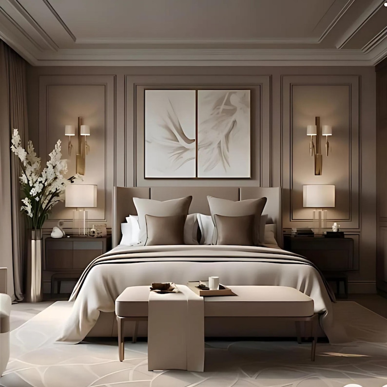 May include: A bedroom featuring a large upholstered bed with beige bedding, two matching nightstands with lamps, and wall-mounted gold sconces. A long bench sits at the foot of the bed, and a tall vase with white flowers stands to the left.