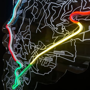 May include: A black and white map of a city with a neon green, yellow, and red line tracing a route. The map includes the names "Tiergarten", "Antonlusbuche", and "Saline Schneiderei Kurort".