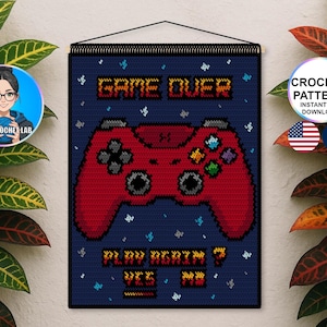 May include: A navy blue crochet wall hanging with a red video game controller design. The text "GAME OVER" and "PLAY AGAIN? YES NO" are in orange pixelated letters. Includes a "CROCHET PATTERN" graphic and a logo.