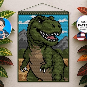 May include: Crocheted wall hanging featuring a green Tyrannosaurus Rex against a blue sky and mountain backdrop. The dinosaur has a wide grin, white teeth, and a tan belly. The text "CROCHET PATTERN INSTANT PDF DOWNLOAD" is visible.