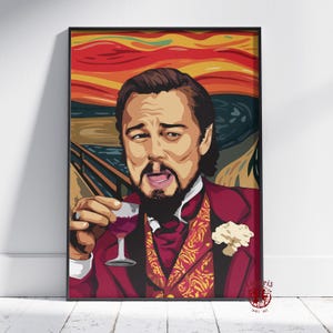 May include: Framed wall art featuring a pop art style portrait of Leonardo DiCaprio holding a glass of red wine. The artwork is set against a backdrop reminiscent of Edvard Munch's "The Scream", with vibrant red, orange, and blue hues. The subject wears a burgundy suit.