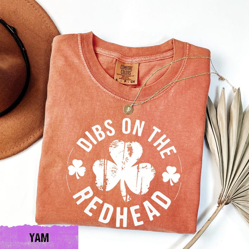 a t - shirt that says dubs on the redhead with a hat next to
