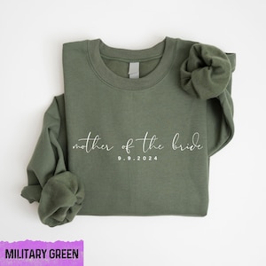 May include: Military green sweatshirt with the text "mother of the bride" and the date "9.9.2024" in white.