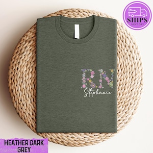 a green t - shirt with a floral design on it