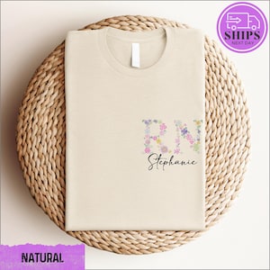 a white t - shirt with a floral design on it