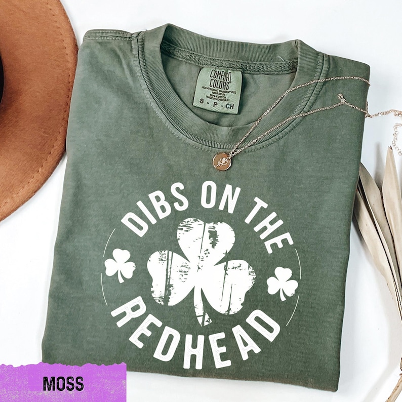 a green shirt with a shamrock on it