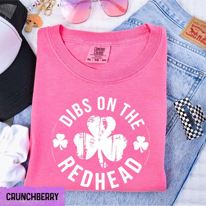 a pink shirt that says dubs on the redhead