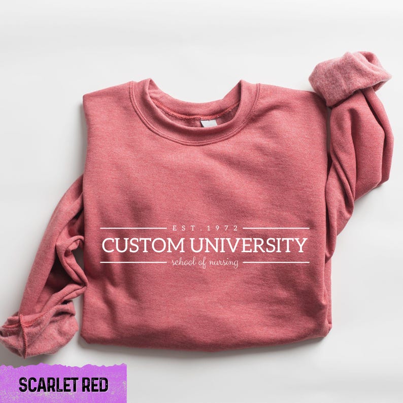 a pink sweatshirt with the words custom university printed on it