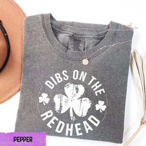 a pair of sunglasses, a hat, and a t - shirt on a table