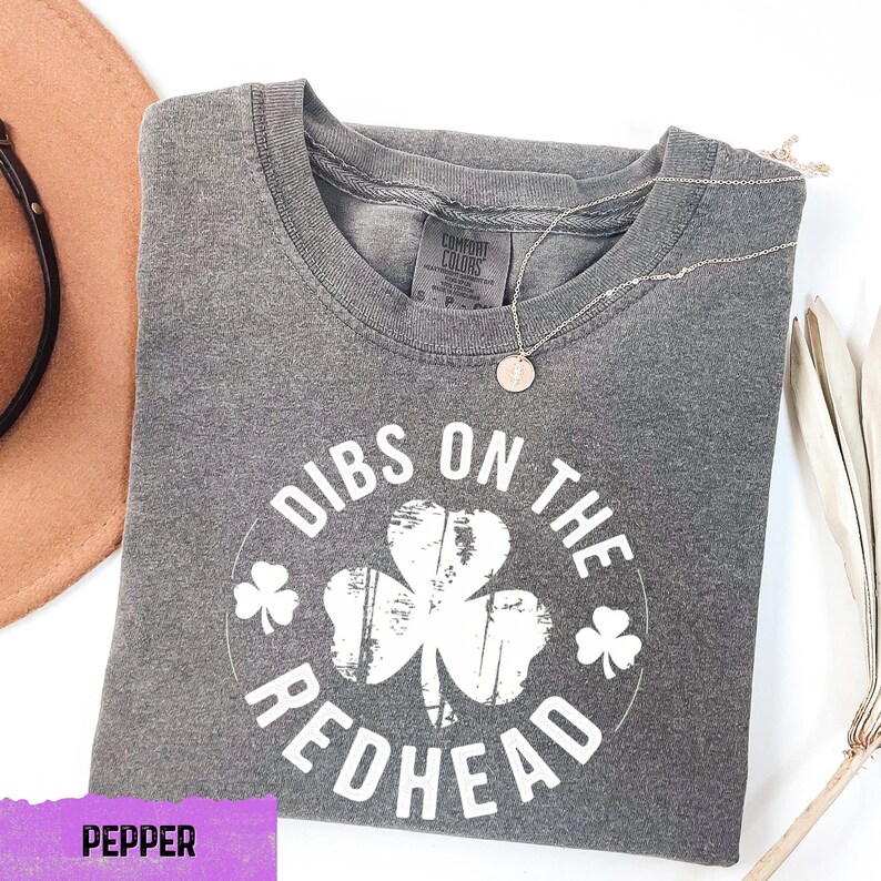 a pair of sunglasses, a hat, and a t - shirt on a table