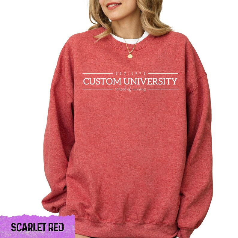 a woman wearing a red sweatshirt that says custom university