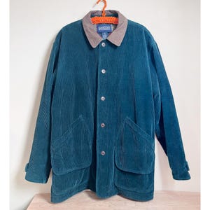 May include: A teal blue corduroy jacket with a brown corduroy collar and a button closure. The jacket has two large pockets on the front and a Lands' End label on the left side of the collar.