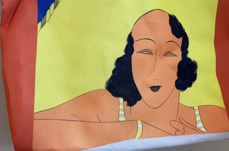 May include: A yellow and orange tote bag with a colorful illustration of a woman with black hair and a striped swimsuit.