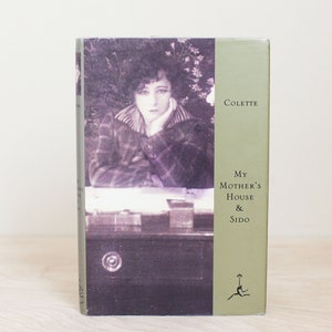 May include: A vintage book cover with a green background and a black and white photo of a woman. The title is "My Mother's House & Sido" by Colette.