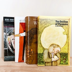 May include: Four vintage paperback books with colorful covers. The book titles are "Bend Sinister" by Vladimir Nabokov, "The Lost", "Henri W" and "The Decline of Pleasure" by Walter Kerr.