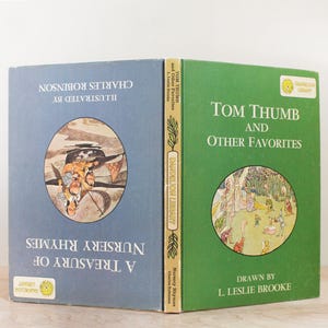 May include: Two vintage children's books with blue and green covers. The book on the left is titled "A Treasury of Nursery Rhymes" and illustrated by Charles Robinson. The book on the right is titled "Tom Thumb and Other Favorites" and drawn by L. Leslie Brooke.