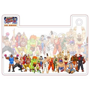 Może przedstawiać: Joystick do gry Street Fighter II Turbo HD Remix z przezroczystą obudową z tworzywa sztucznego i kolorowym obrazkiem postaci z gry na przodzie. Postacie to Ryu, Ken, Chun-Li, Guile, Blanka, Zangief, E. Honda i Sagat.