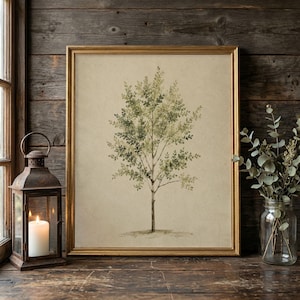 May include: A framed wall art print featuring a watercolour illustration of a single tree with green leaves on a beige background. The artwork is enclosed in a thin gold frame, showcasing a detailed botanical depiction of a slender tree.