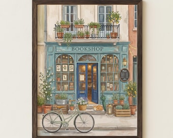 May include: Watercolor print of a quaint bookshop with a blue facade and the word "BOOKSHOP" above the entrance. A bicycle with a basket of flowers sits in front. Potted plants and a cat add to the charming scene. The print is framed in a dark brown wooden frame.